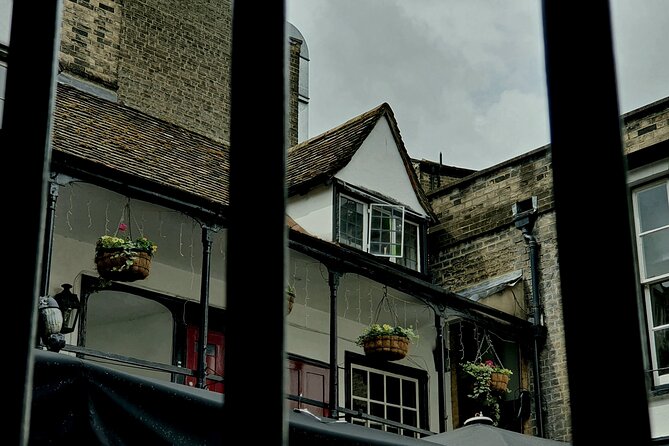Creepy Cambridge - Cambridge's Most Entertaining Ghost Walk - St Bene’t’s Church and a pub with an open window