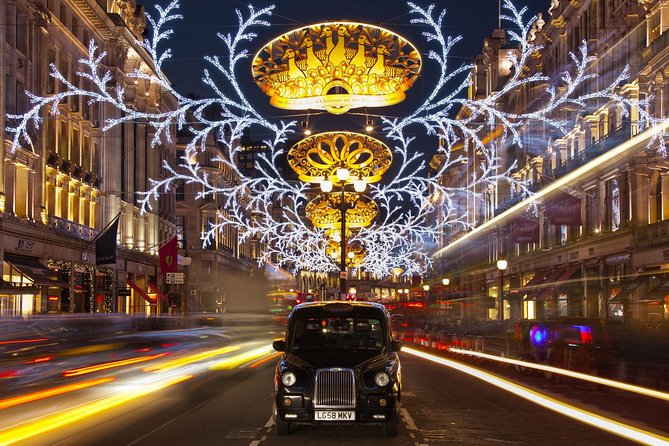 London by Night Bus Tour with Christmas Lights and Live Guide - The Strand and the glowing Savoy figures